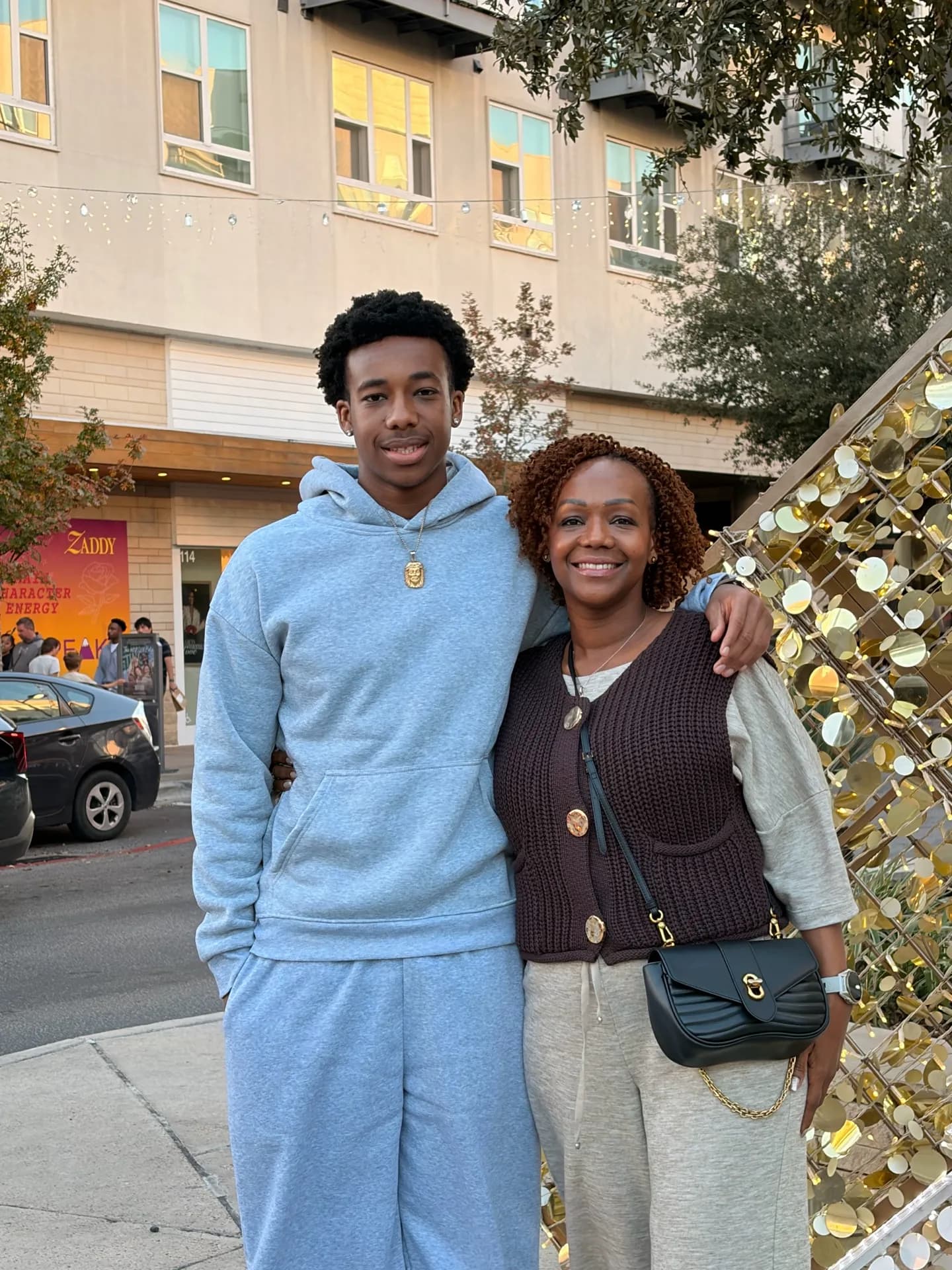 Rose with her older son on a city street
